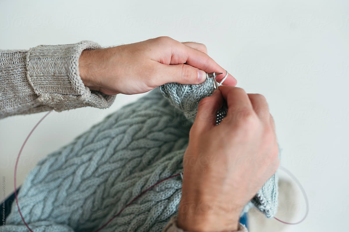 Hands of knitting male.
