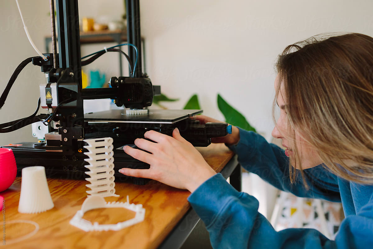 Designer working on a 3D printer