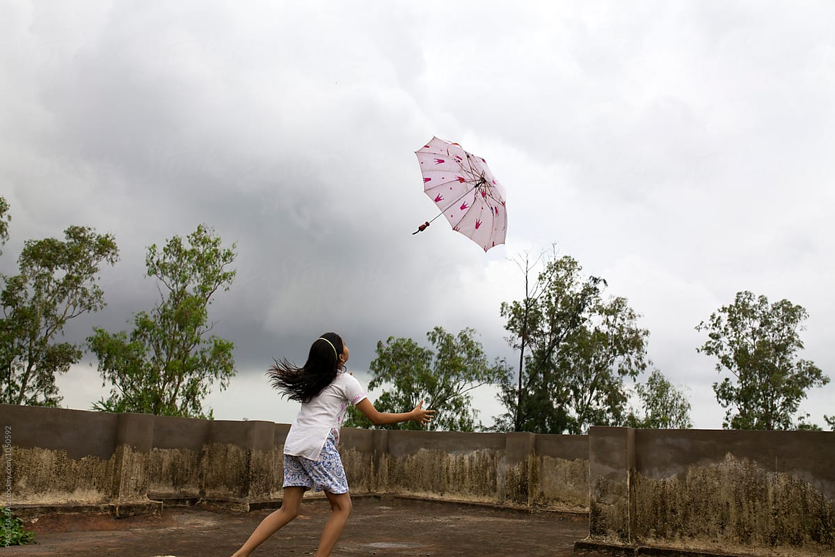 "Monsoon Season With Umbrella In Air" by Stocksy Contributor "Dream