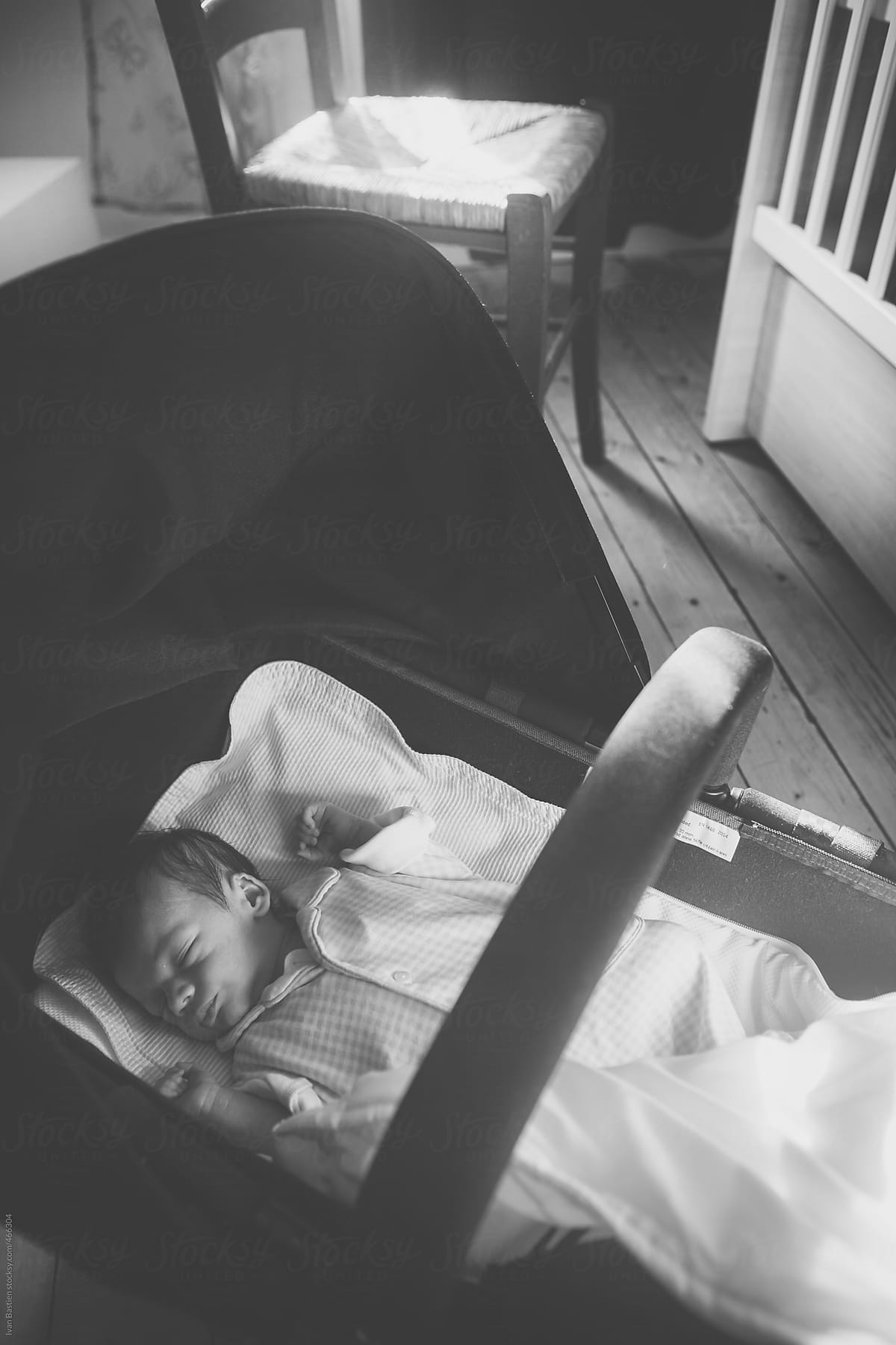 One week old baby boy in a bassinet in his bedroom