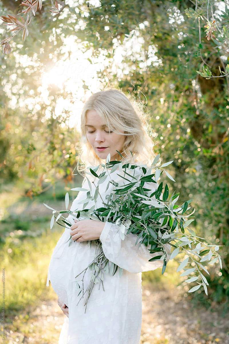 Elegant pregnant female in olive grove