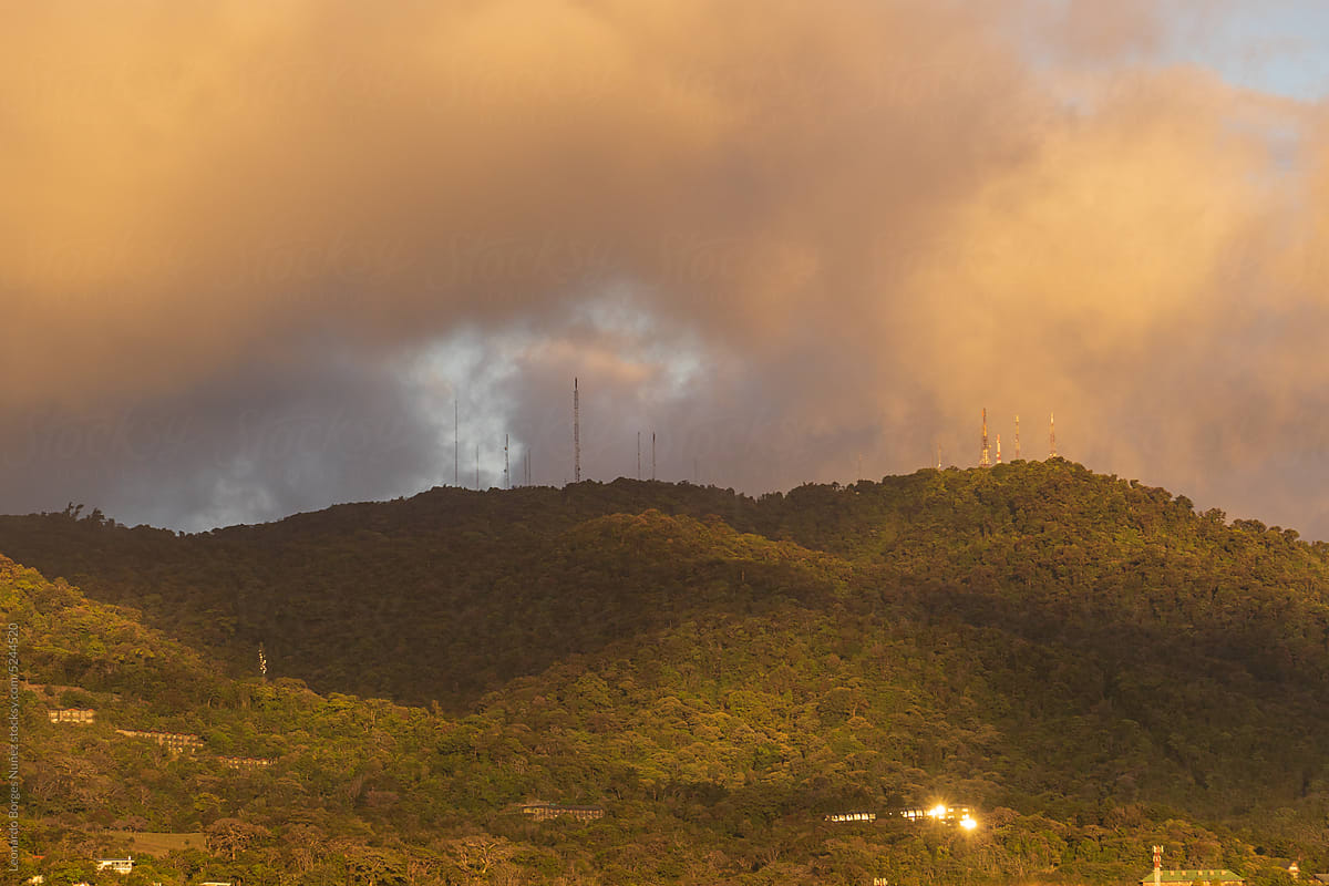 wooded mountain with communication towers
