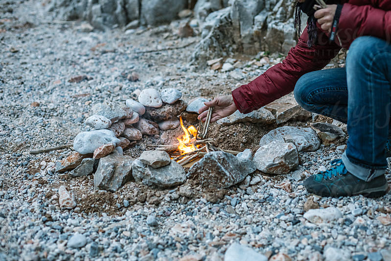 young woman preparing bonfire, greece, crete