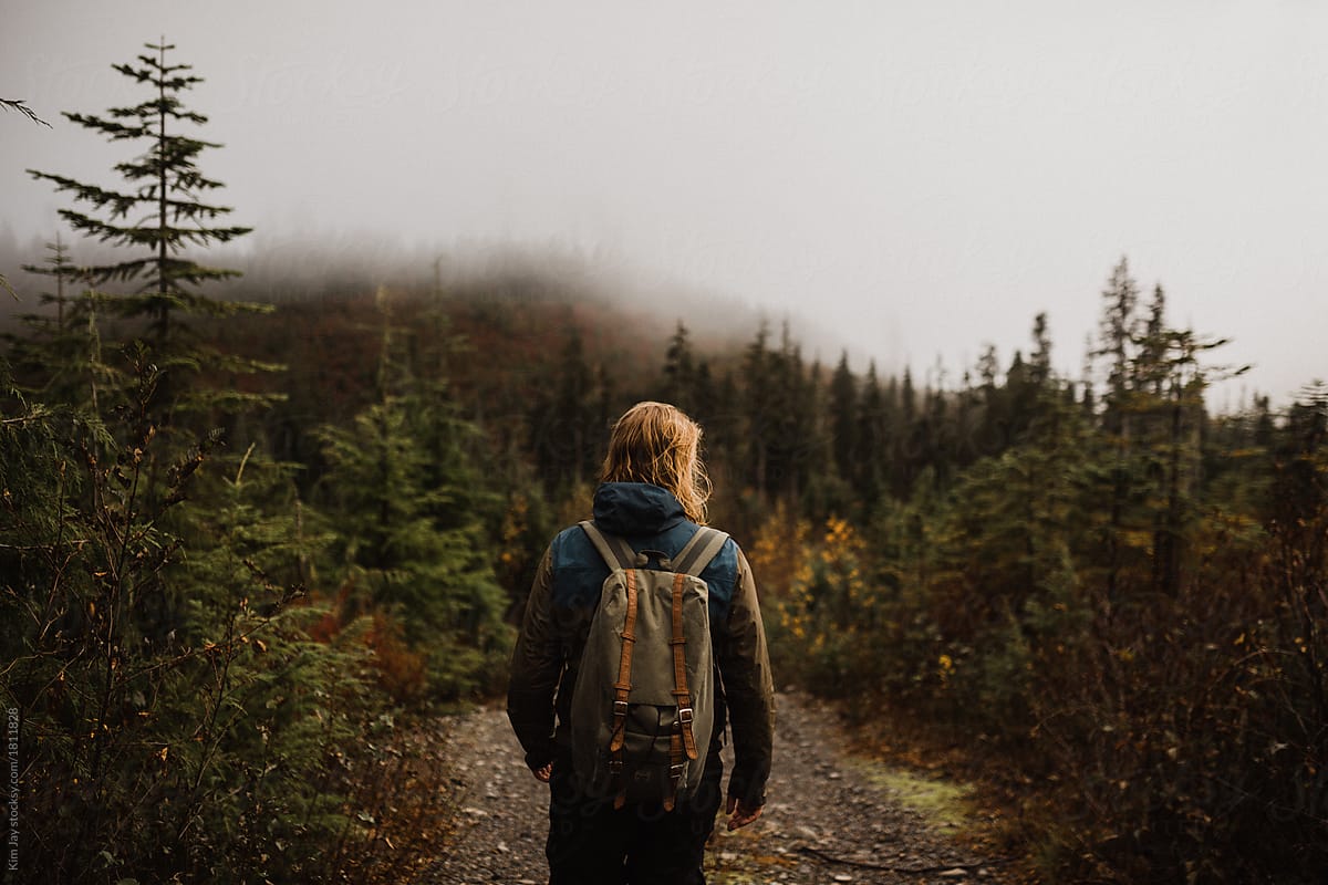 Man hiking on a foggy day on the west coast in British Columbia