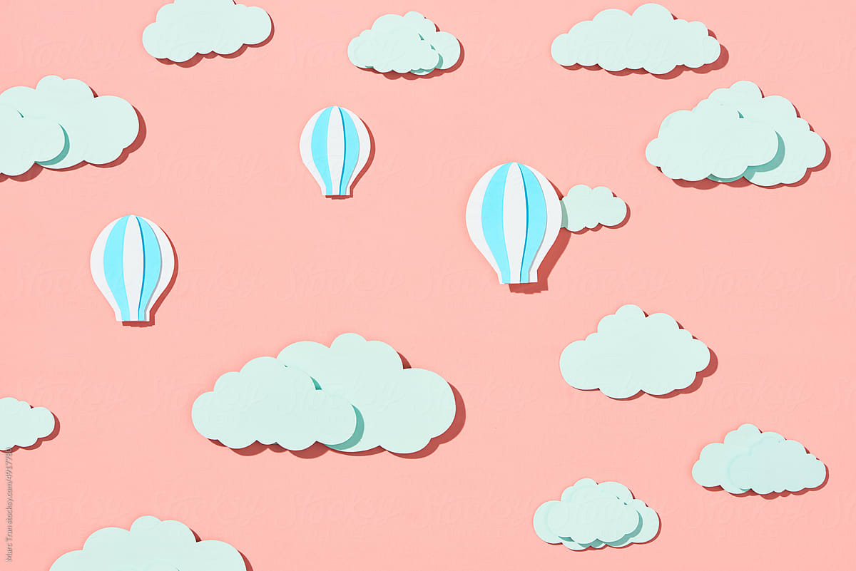 Hot air balloon flying on the sky with cloud. Paper art style