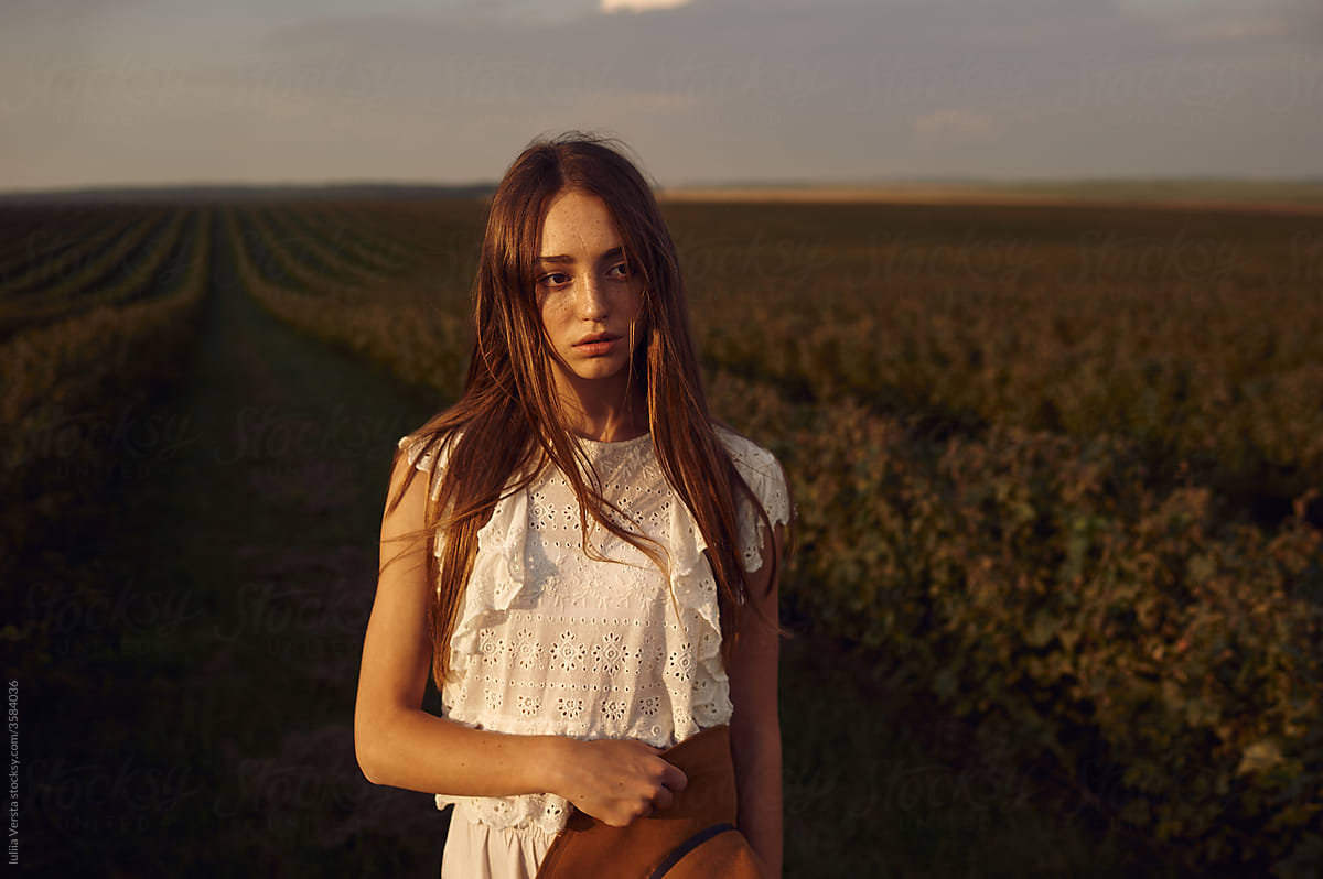 Portrait of red-head girl a field