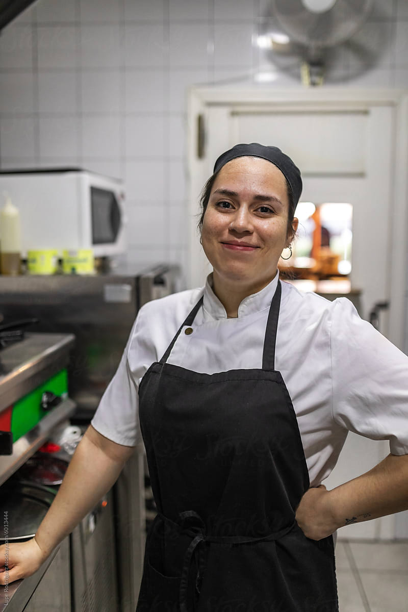 portrait of young female chef in the kitchen of a restaurant