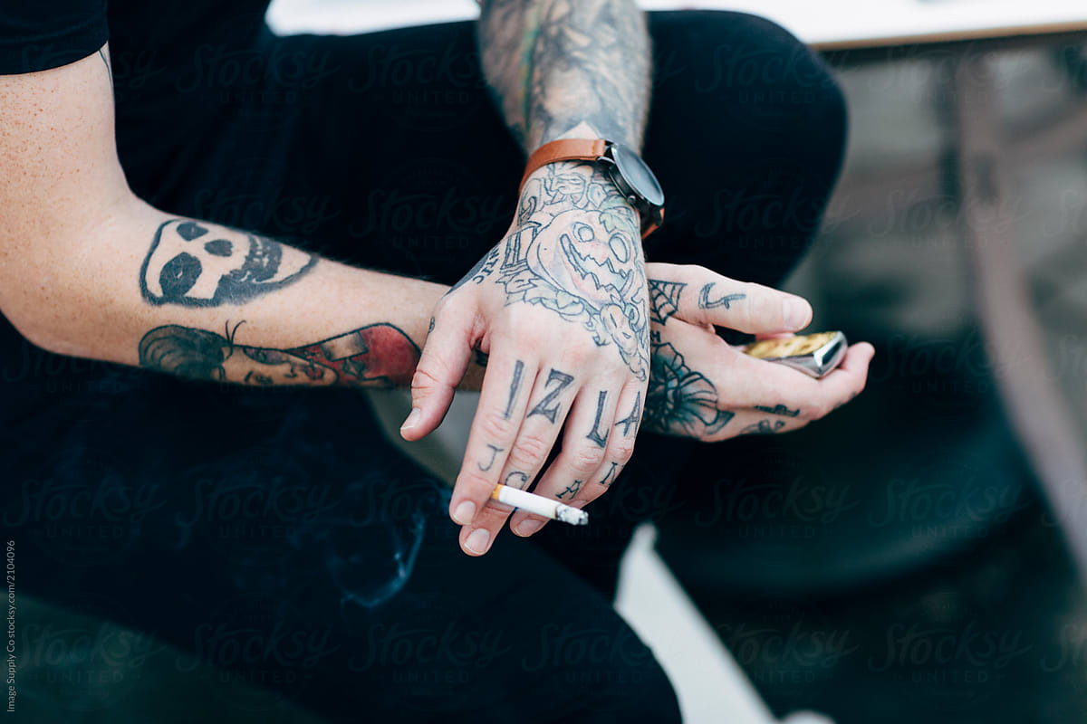 White tattooed male smoking.