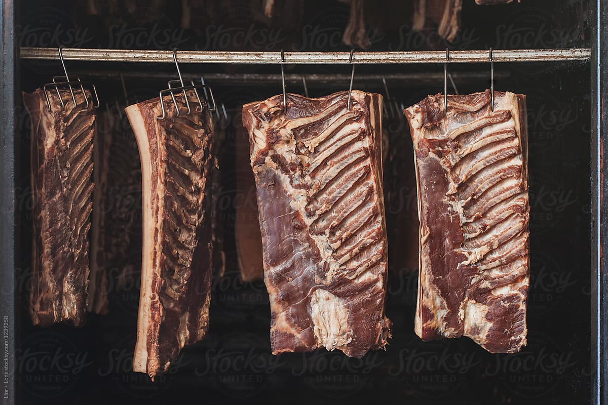Aged bacon hanging in a smoke chamber
