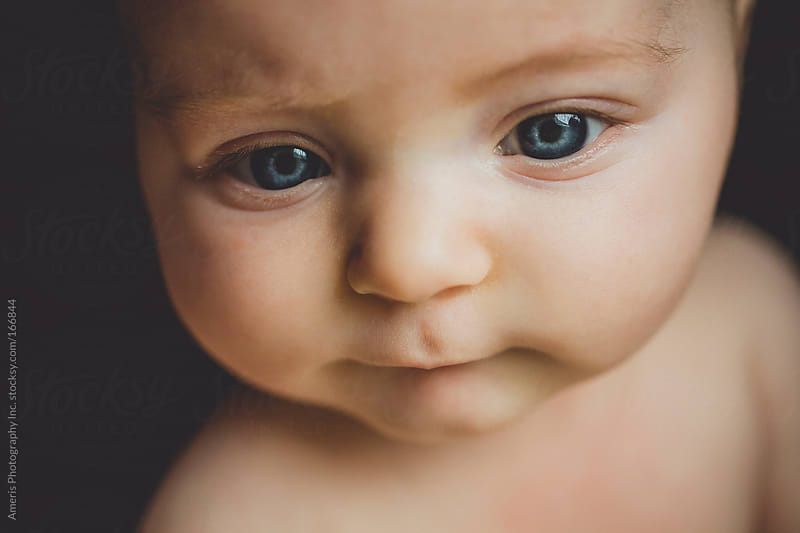 Close up of cute naked baby girl with blue eyes