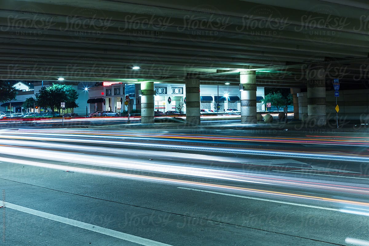 light trails of cars through overpass