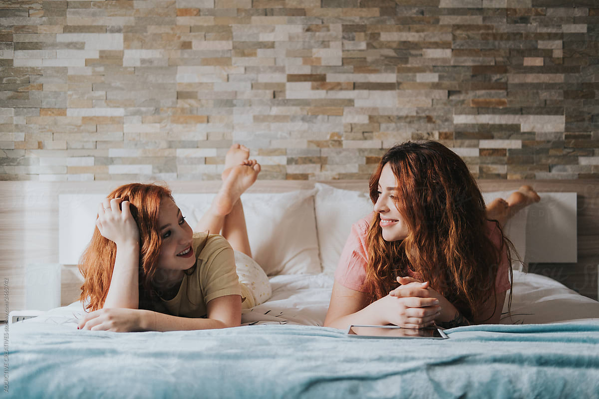 Smiling Women Resting On Bed By Addictive Creatives Stocksy United 