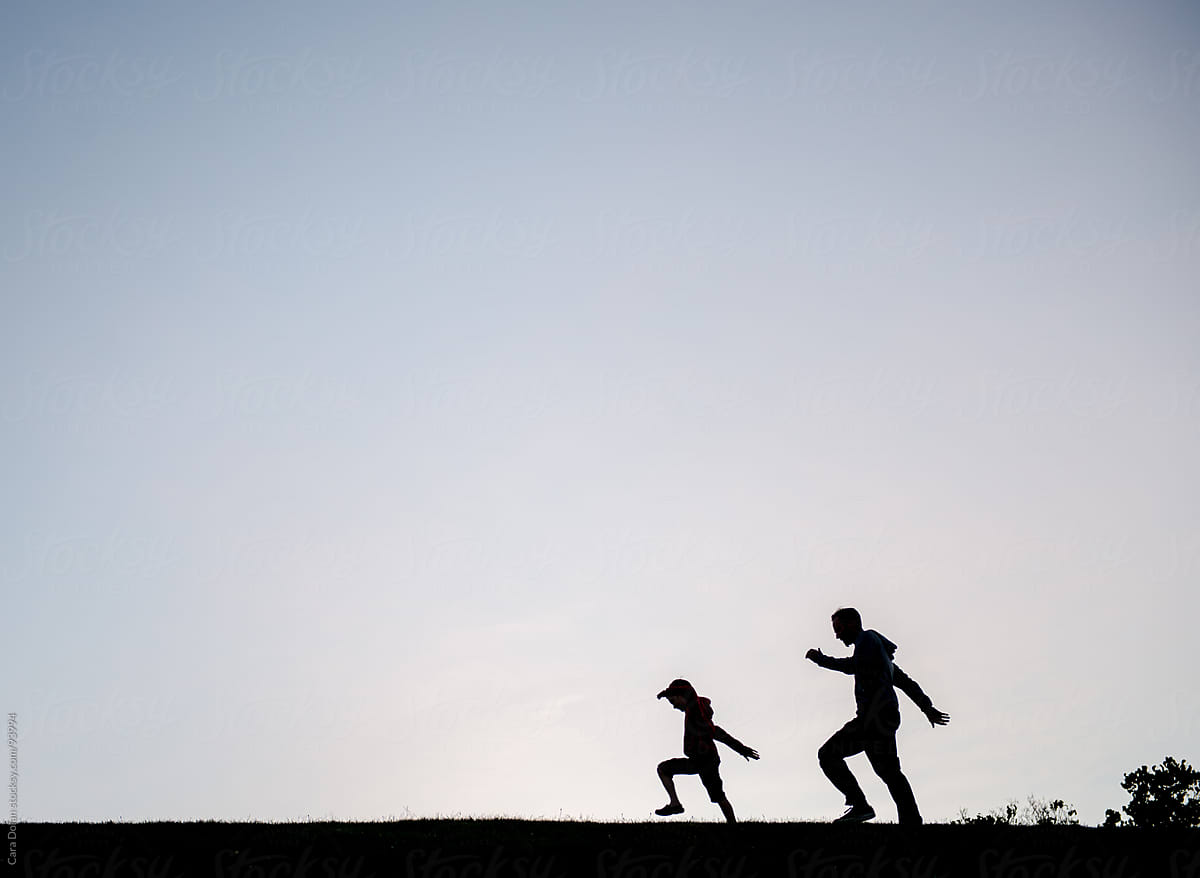father and son walking silhouette