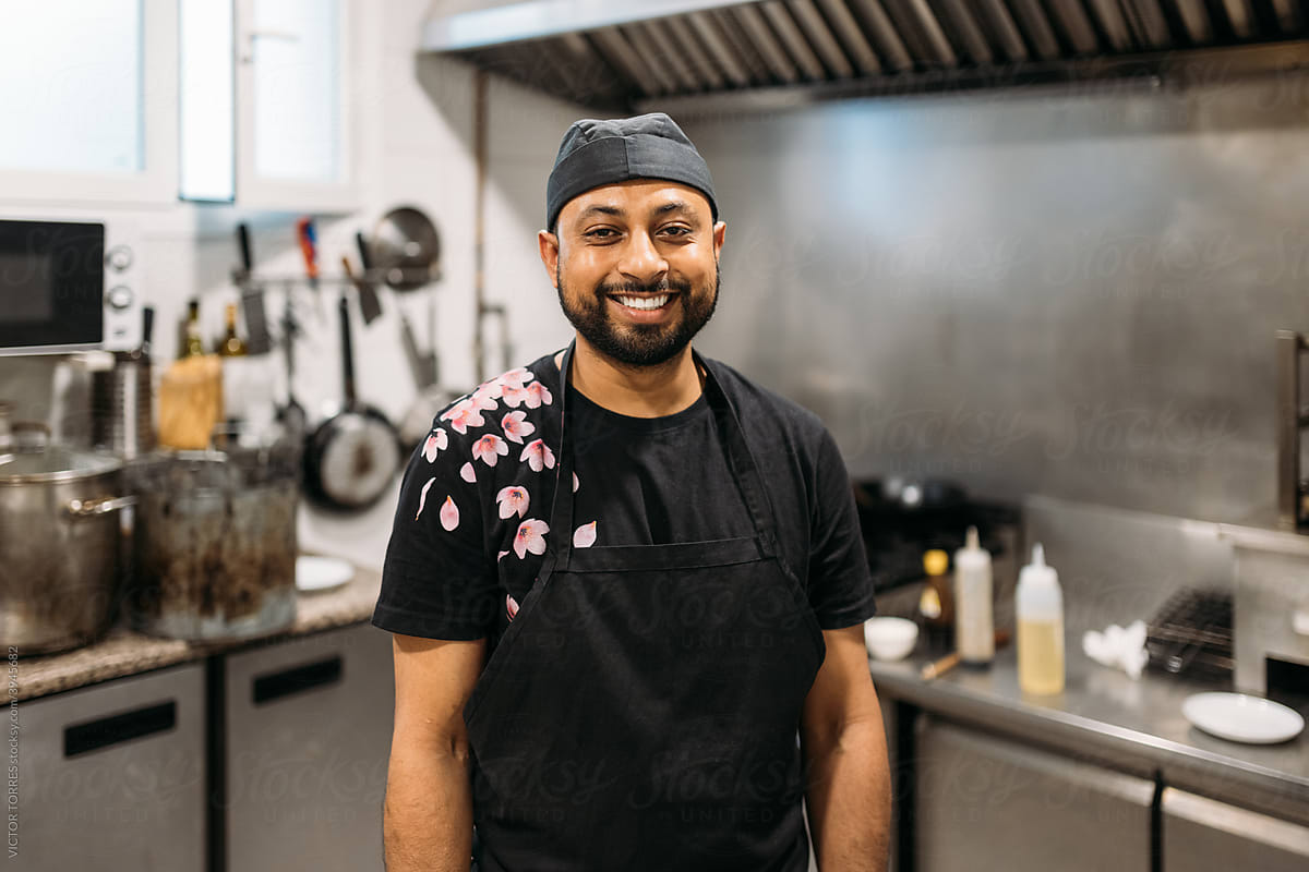 Indian chef posing in a restaurant kitchen