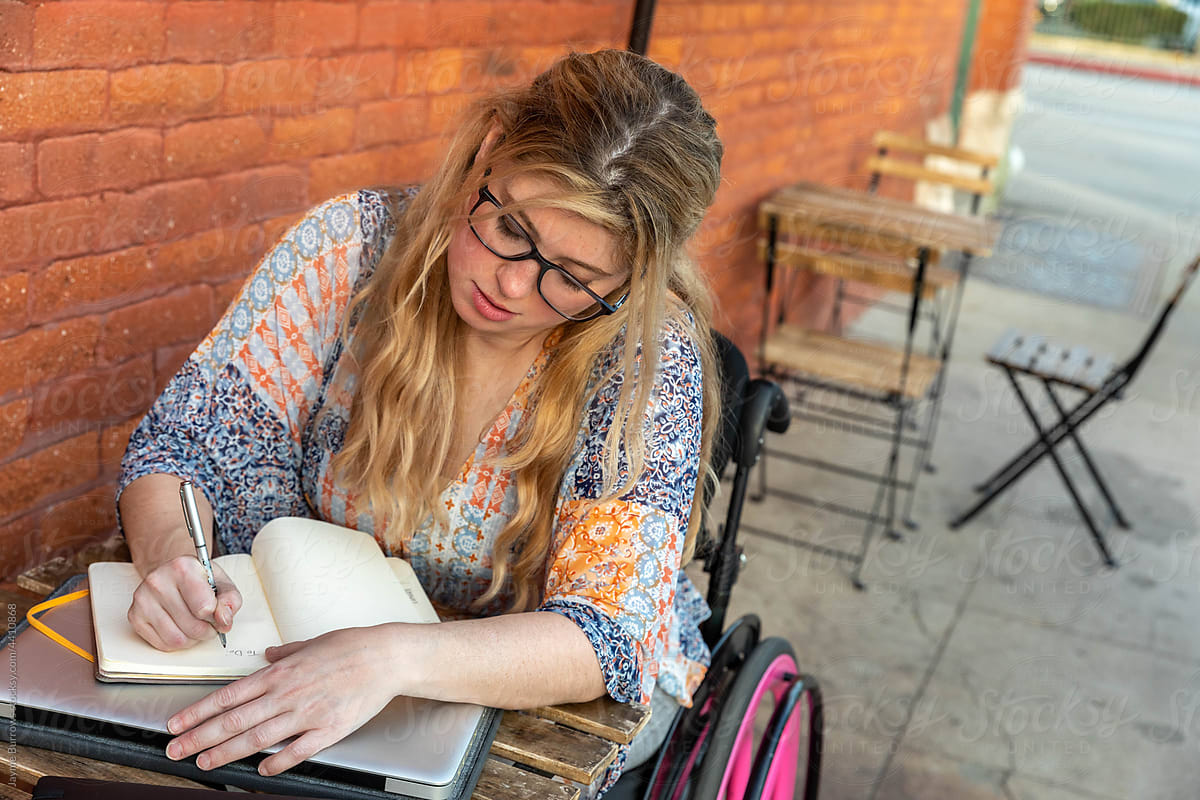 Disabled Woman Writes in Journal at a Cafe