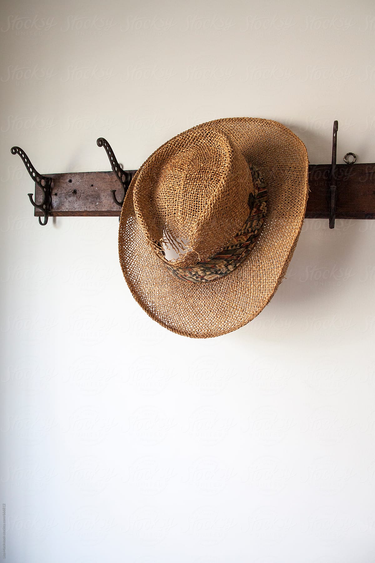 Straw hat on vintage coat rack