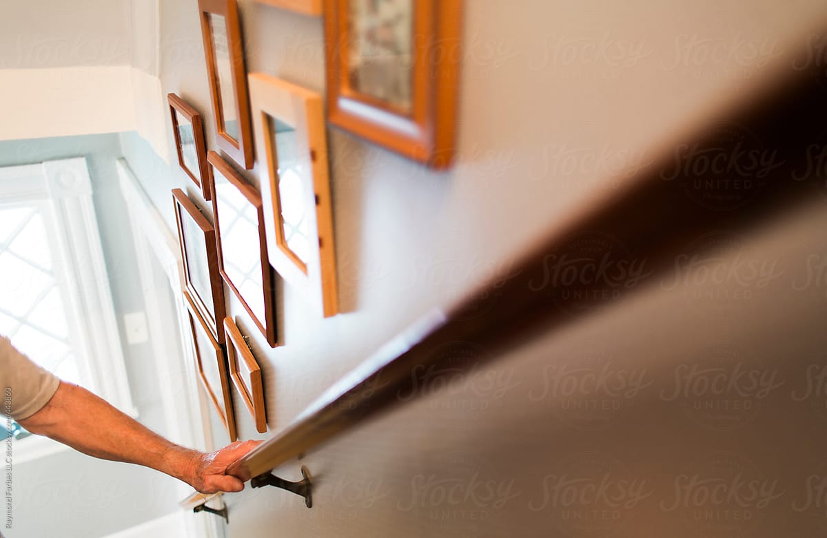 Low angle of Senior Walking down stairs at home