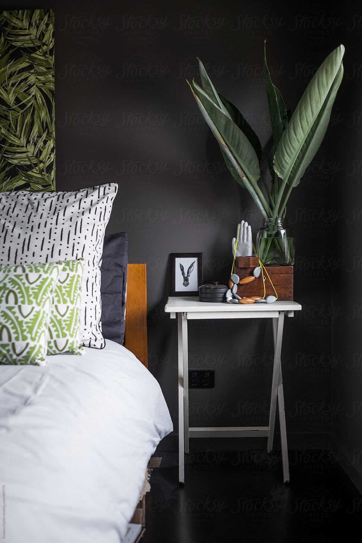 Dark styled bedroom interior with black painted wall