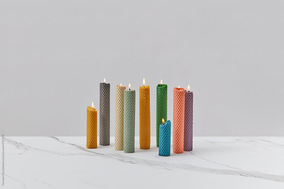 Burning multi-colored patterned beeswax candles.