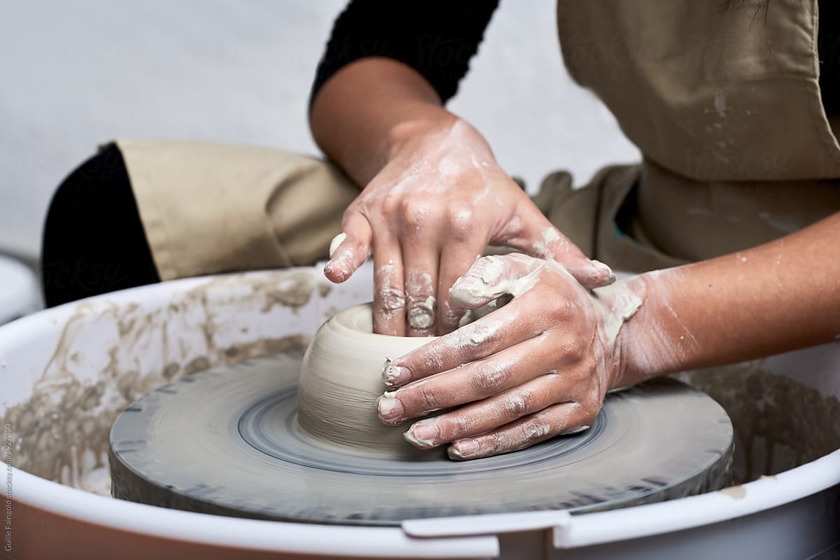 Anonymous craftsman making pot from clay