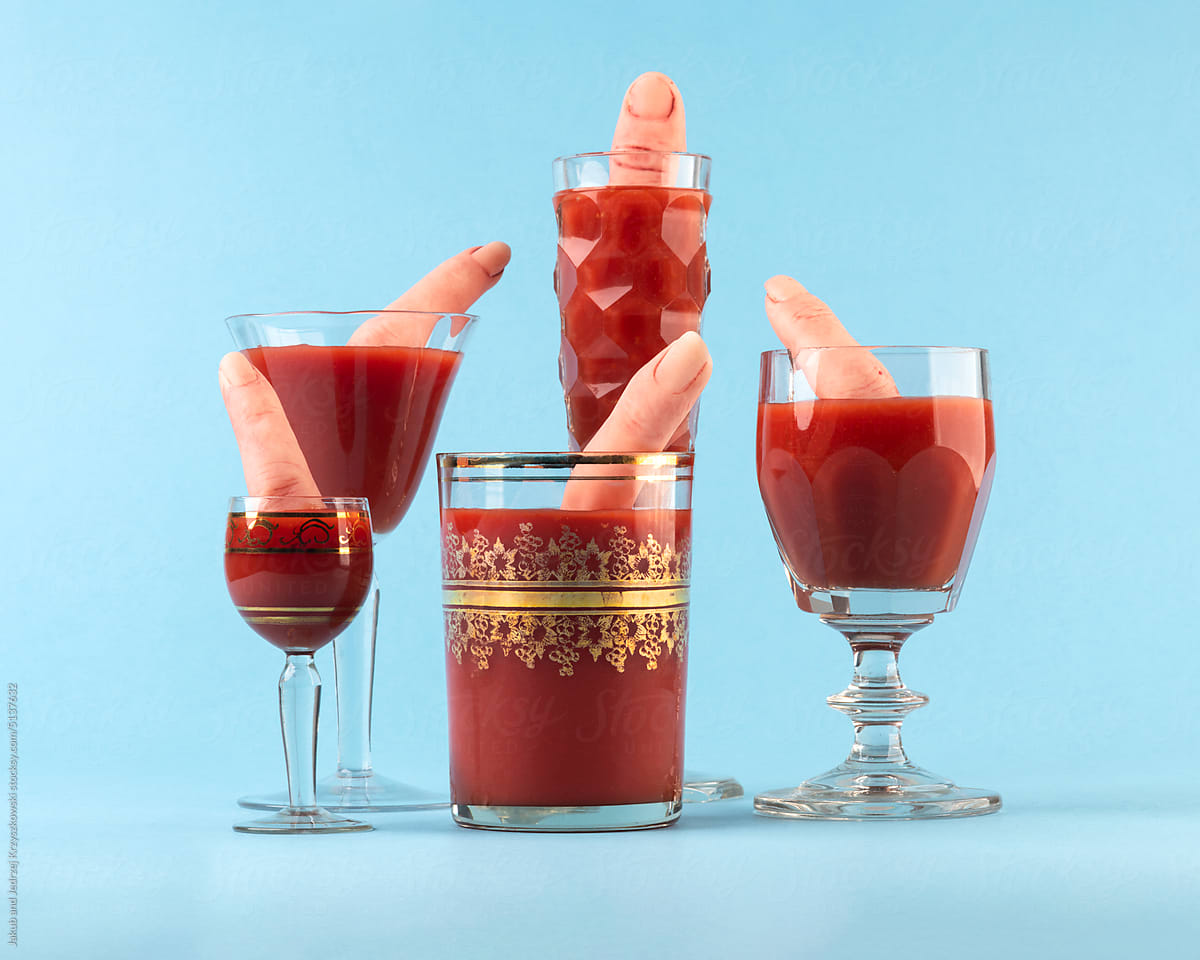 Blood cocktails with fingers in crystal glasses