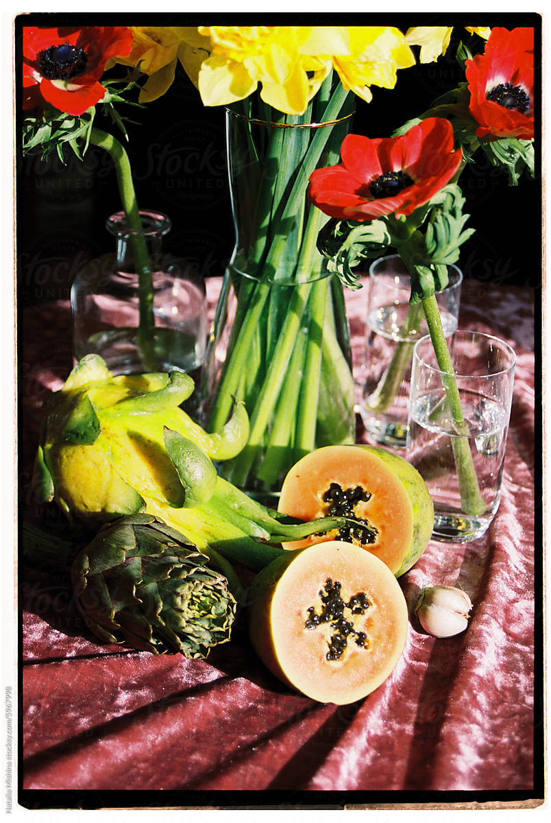 A bright exotic still life with pitahaya and anemones.
