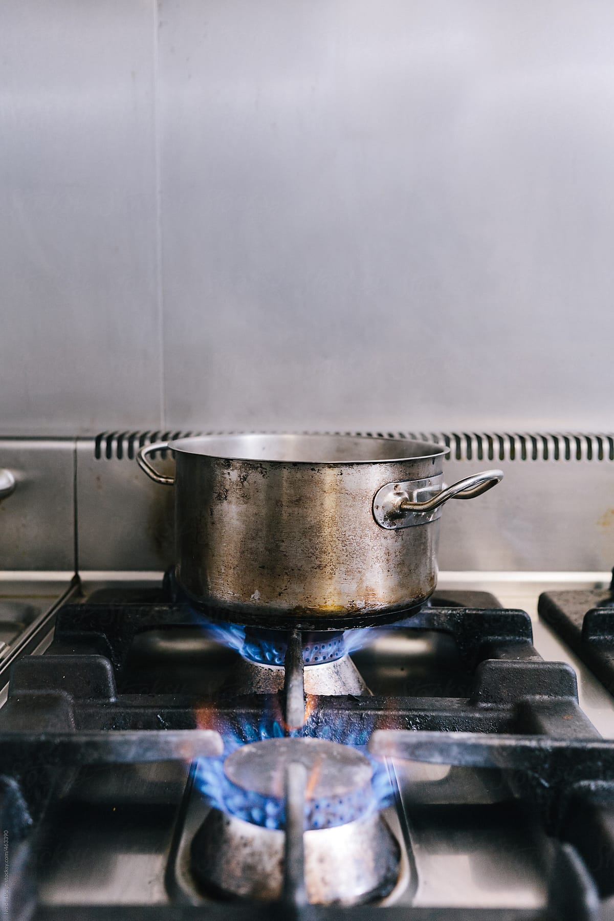 A pan with water being heated on a stove