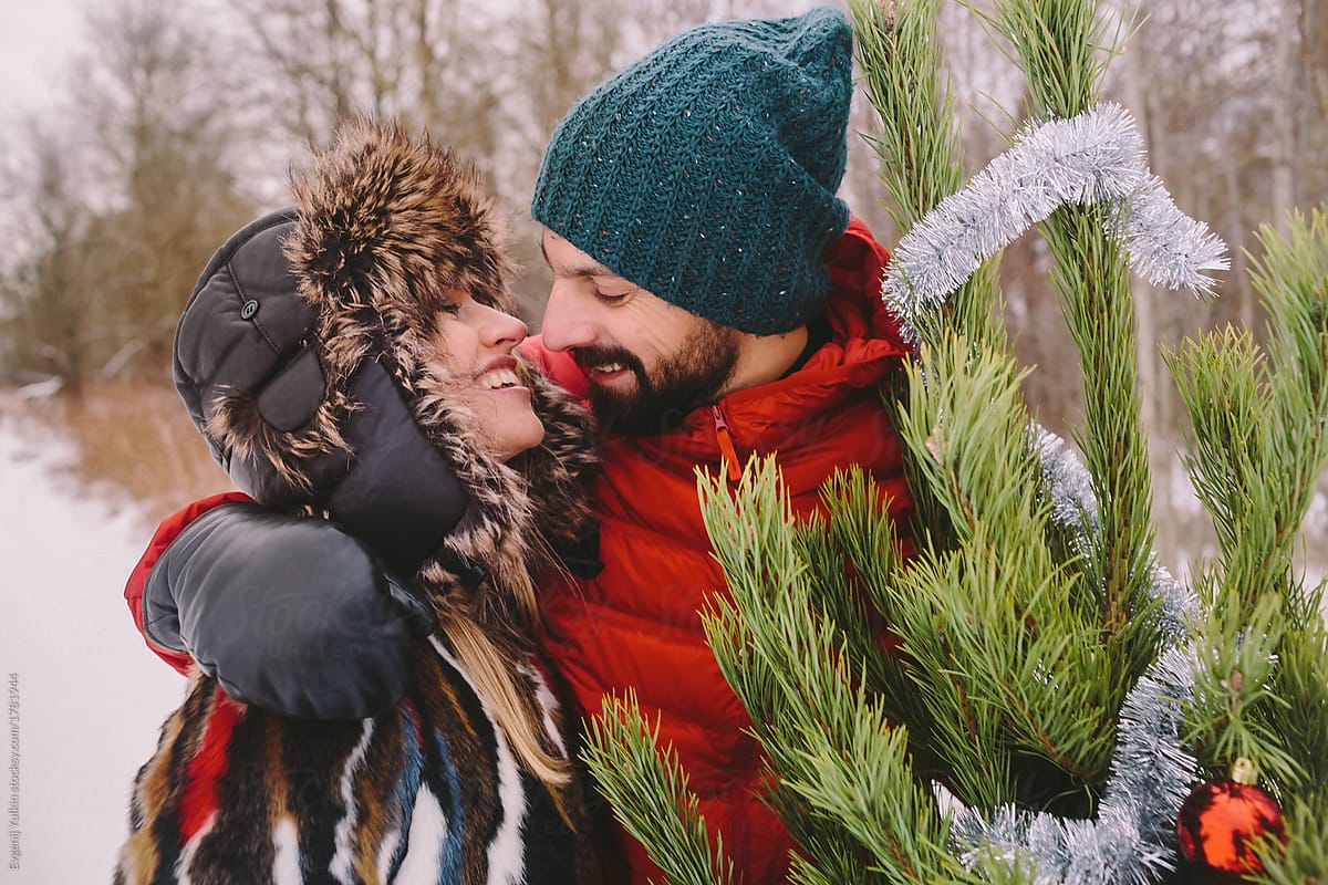 Kissing couple next to christmas tree