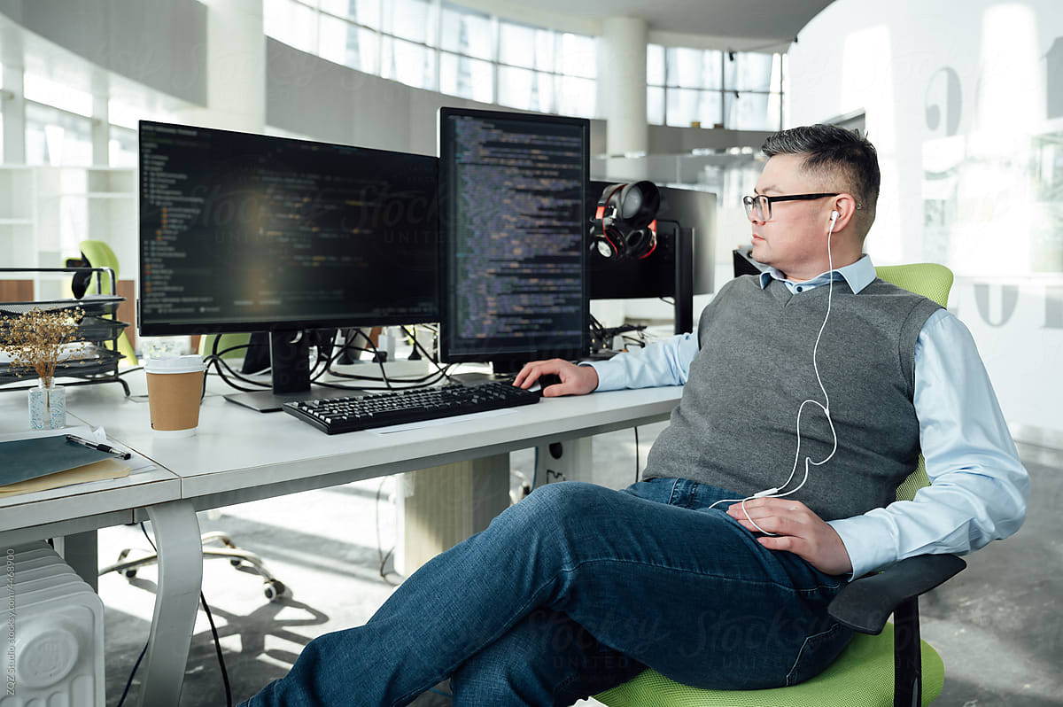 Portrait of Chinese male engineer with computer in office