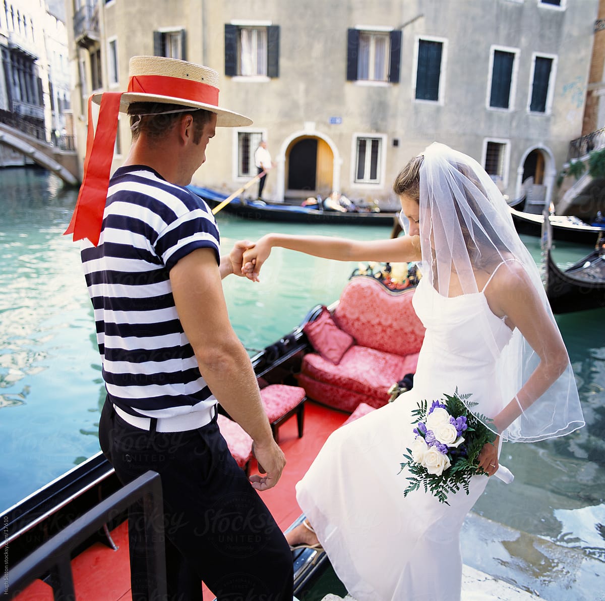 Bride getting into gondola. Venice. Italy.