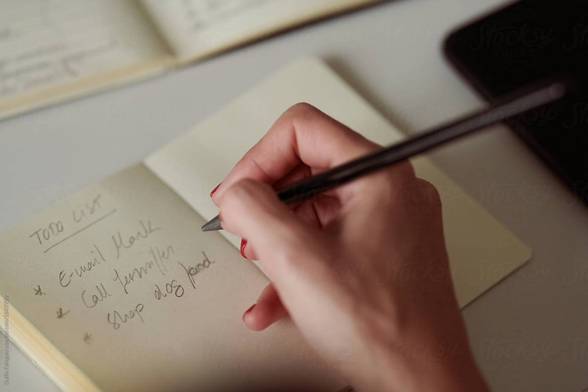 Female hand writing to do list