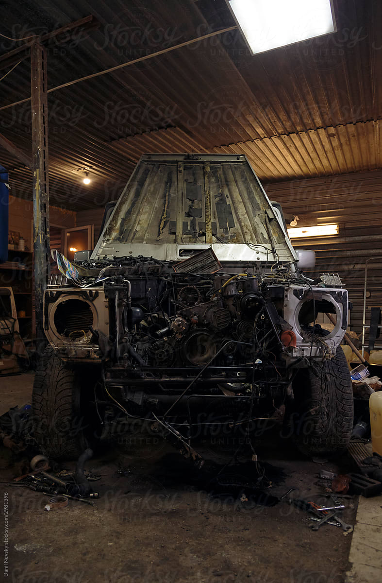 Disassembled car in grungy garage