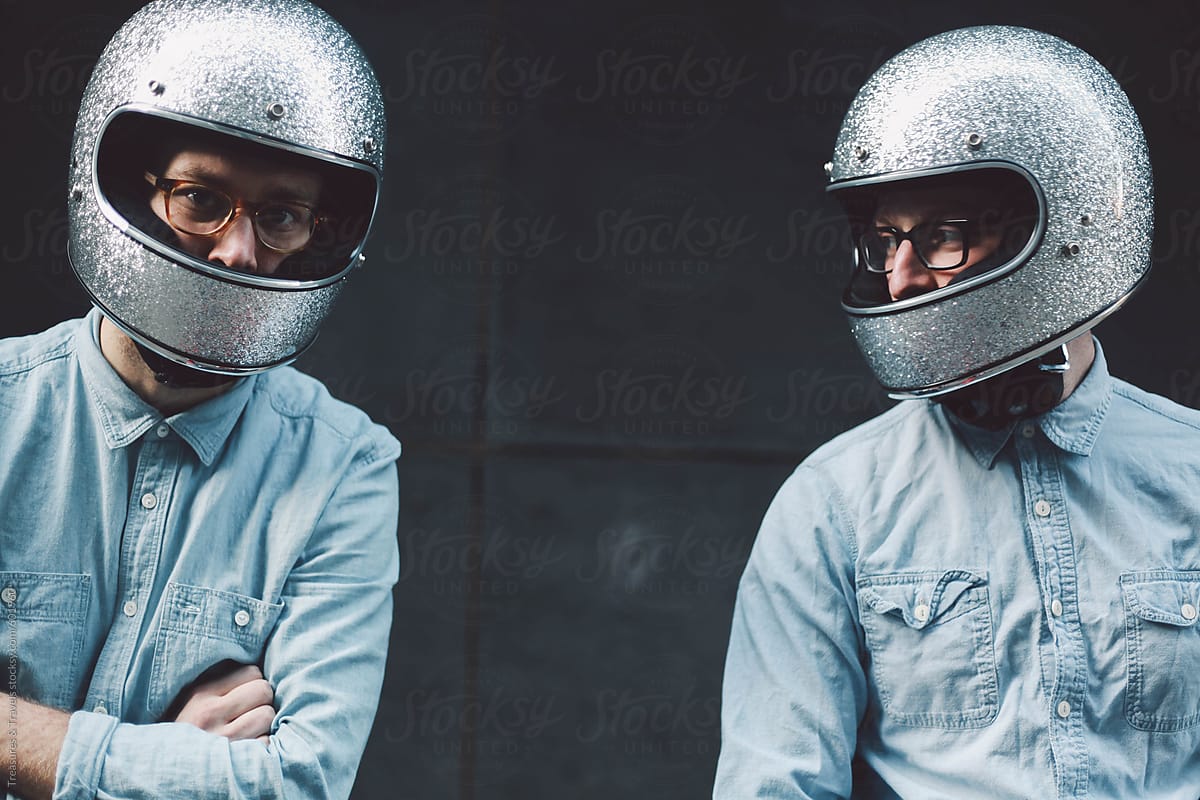 "Two Young Men Wearing Motorcycle Helmets" by Stocksy Contributor "Pink