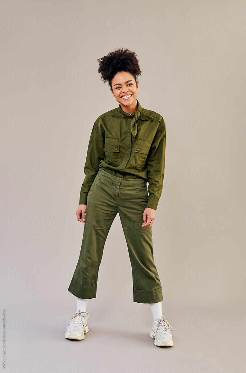 Portrait of a young woman standing wearing a uniform jumpsuit