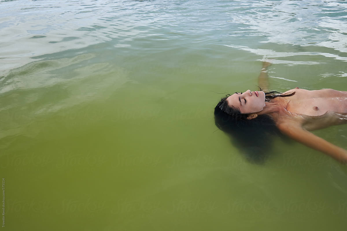 Woman floating in ocean water