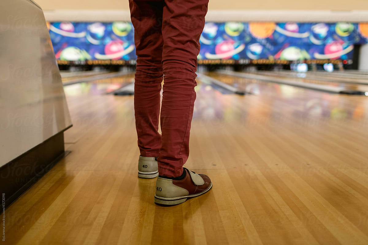 Bowling Shoes And Bowling Ball In Bowling Alley by Stocksy