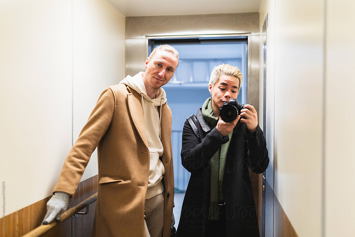 Self-portrait picture of male couple in elevator