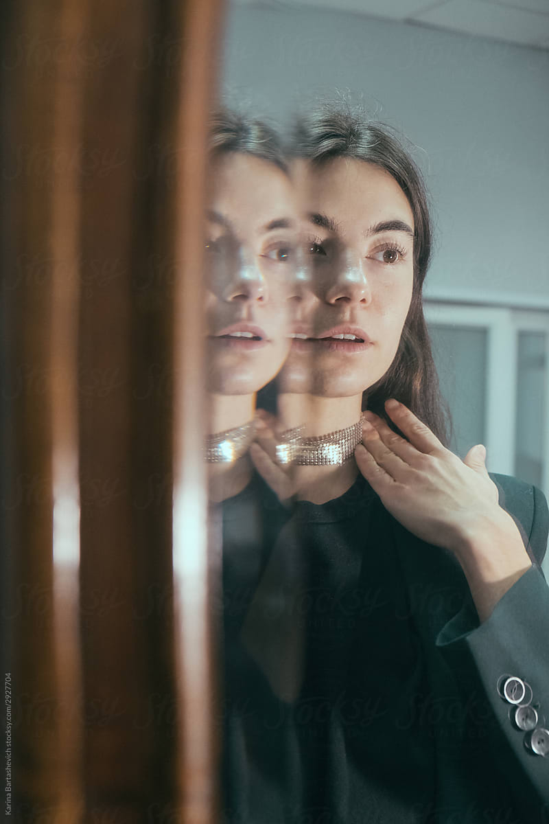 Portrait of girl in the reflection of a mirror with a wooden frame