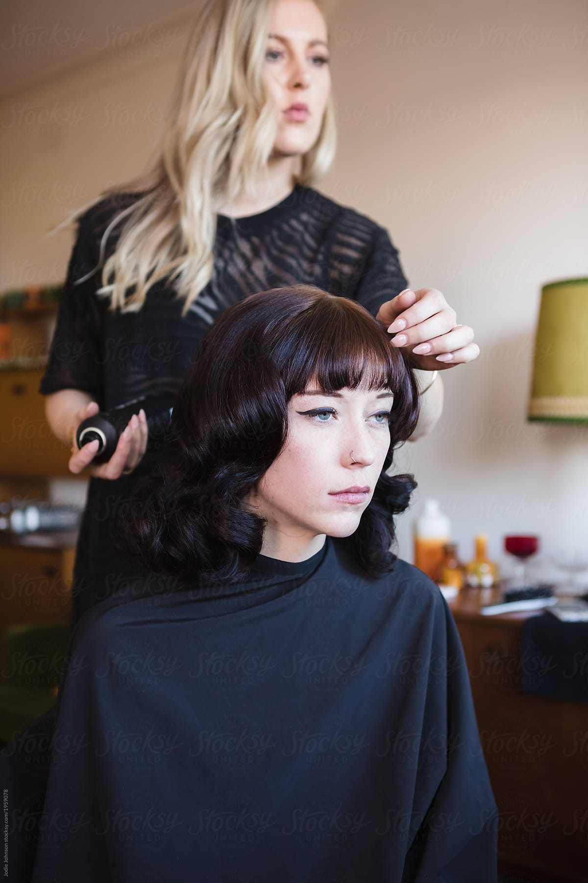A hair stylist working on a model