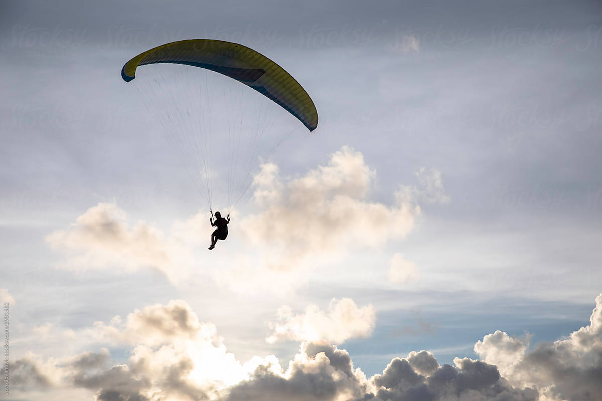 Person paragliding and enjoying freedom in the sky