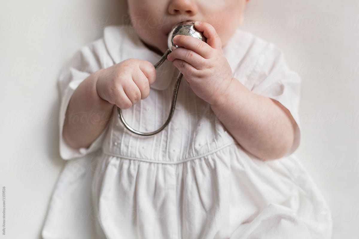baby holding rattle