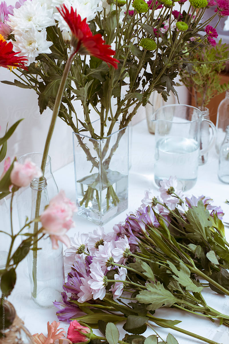 a variety of flowers in vases on the table.