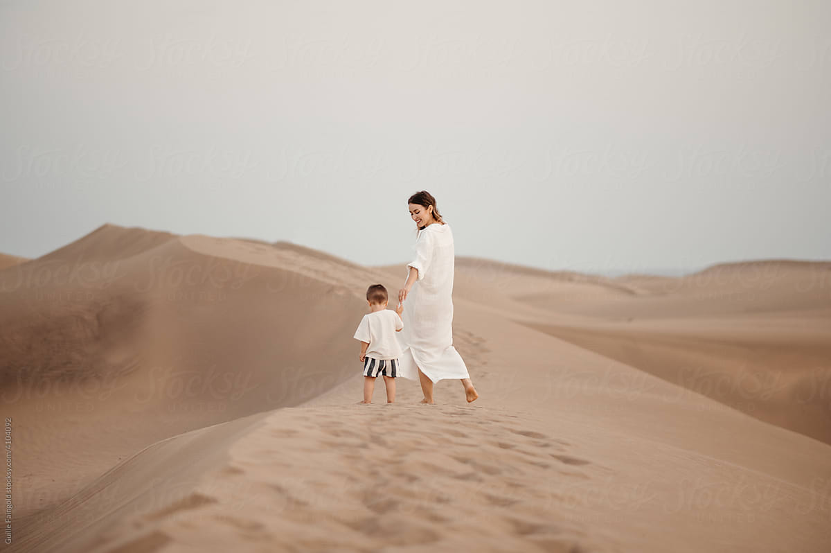 Happy mother with son in desert.