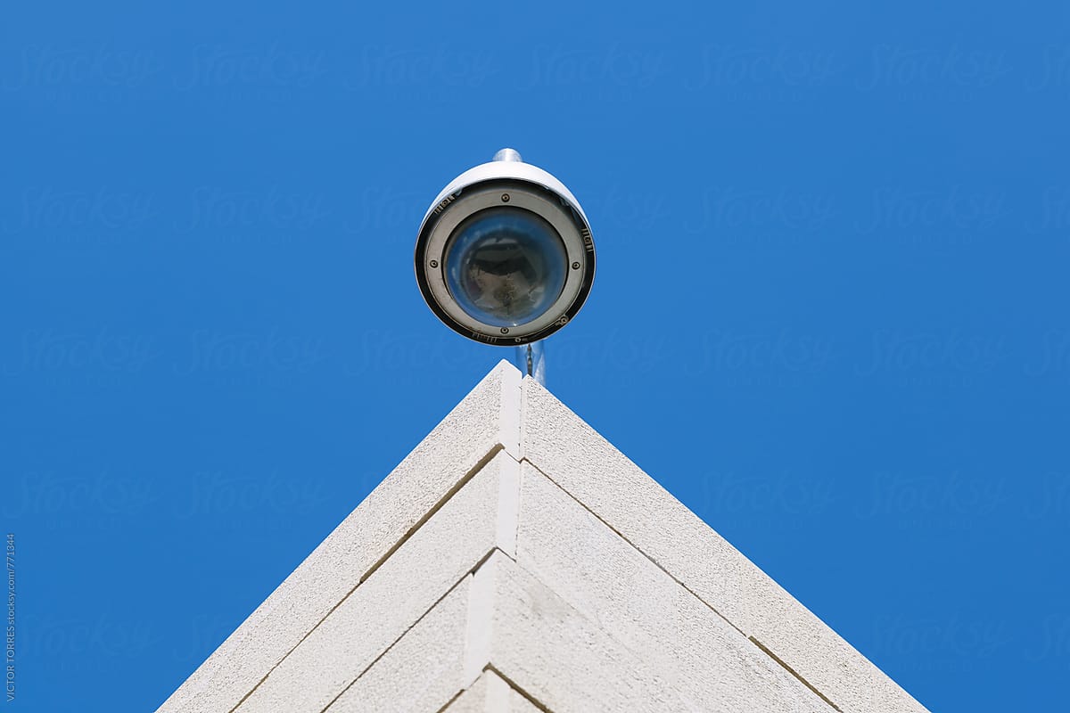 Security Cam on a Top Roof Against a Radiant Blue Sky