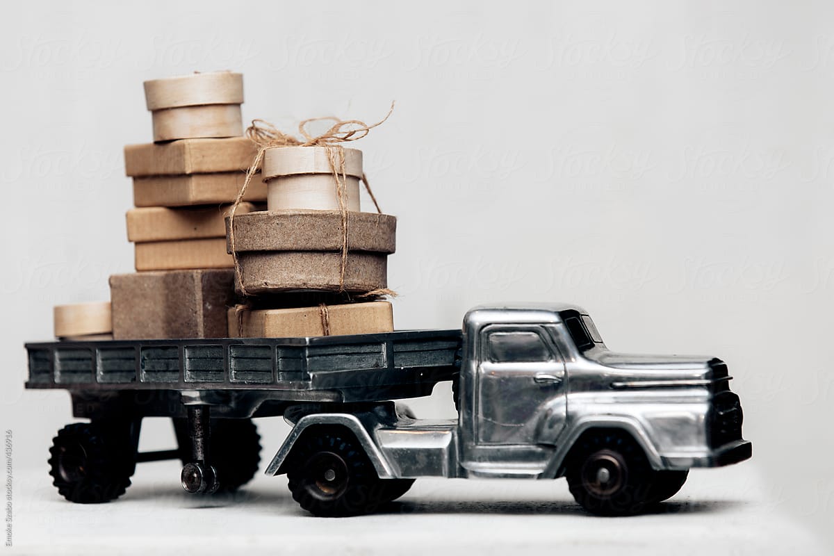 Christmas gift boxes on old toy car mechanical horse and trailer