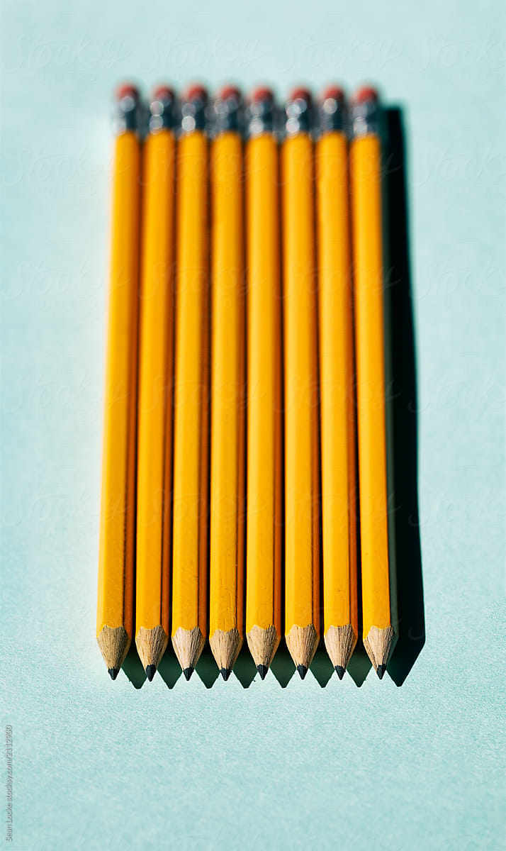 Row Of Pencils On Blue Background