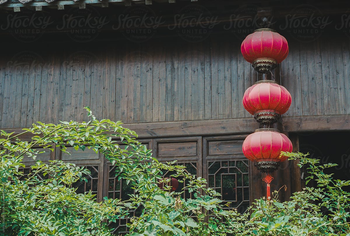 decorative red lanterns hanging on tiled roof