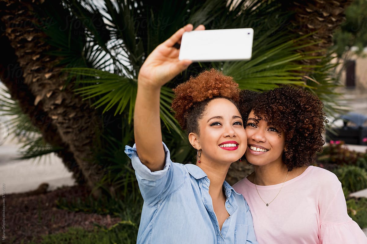 Girlfriends using a mobile phone for a selfie