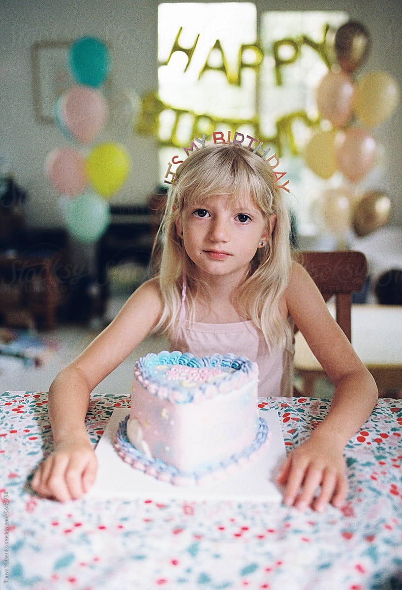 A girl with a birthday cake at home