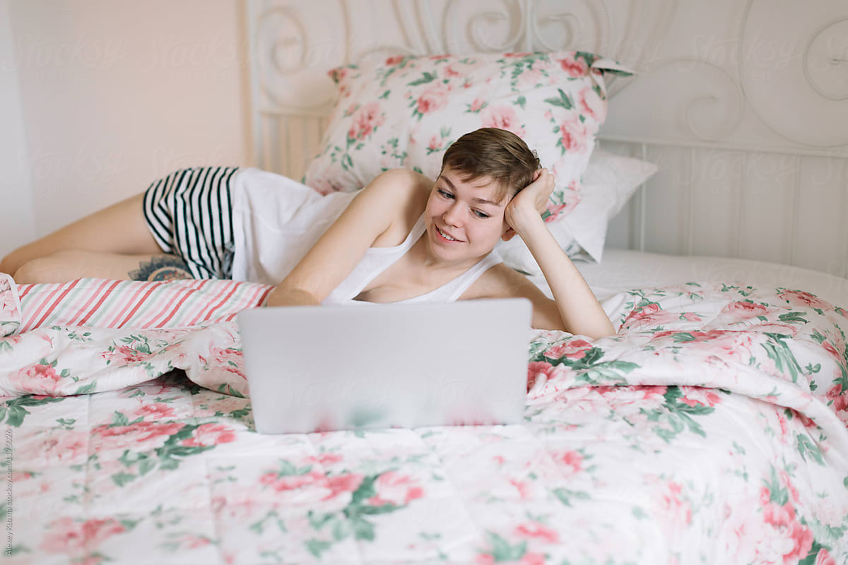 young woman relax with laptop on the bed